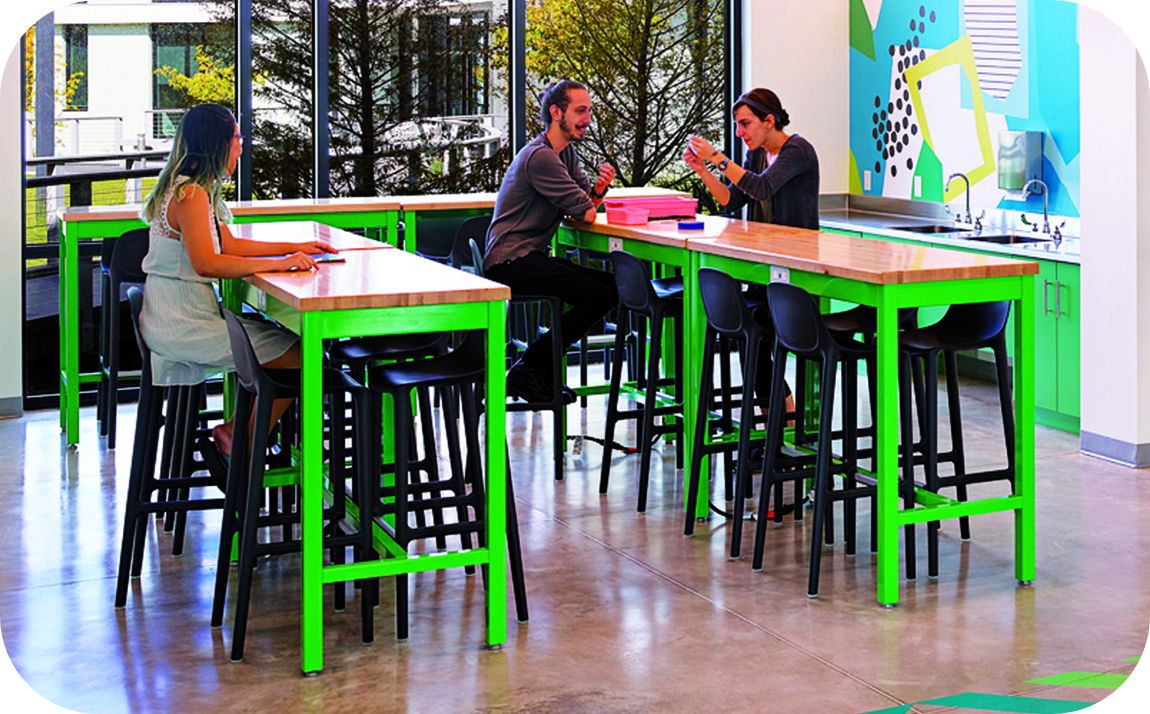 Coby apron high top tables in cafeteria - tables have bright green finish on legs